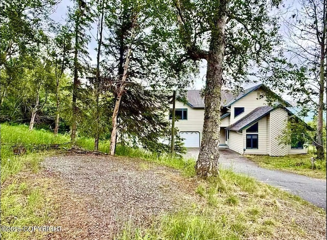 19440 Timberline Dr, Eagle River, AK 99577 - view of home's exterior featuring asphalt driveway and a garage