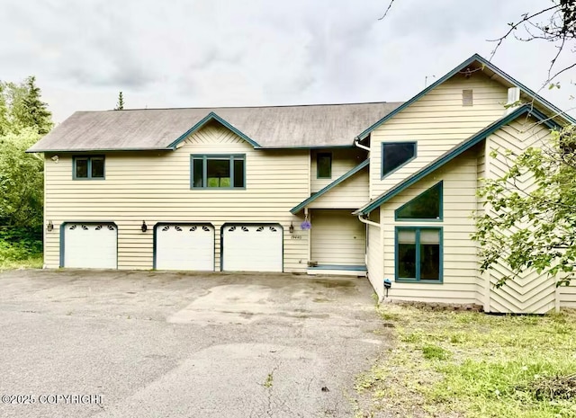 19440 Timberline Dr, Eagle River, AK 99577 - view of front of home featuring a garage and asphalt driveway