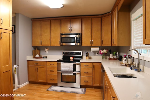 1468 Davison Rd, North Pole, AK 99705 - kitchen featuring light countertops, light wood-style floors, stainless steel appliances, and a sink