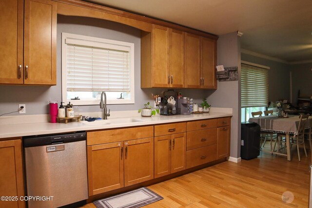 1468 Davison Rd, North Pole, AK 99705 - kitchen with light countertops, a sink, light wood-type flooring, brown cabinets, and dishwasher