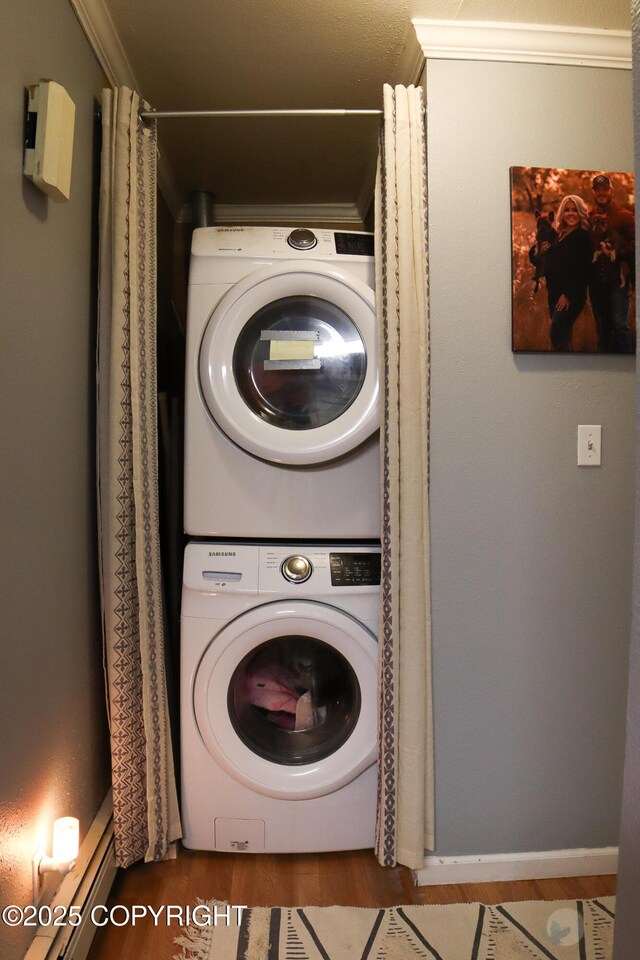 1468 Davison Rd, North Pole, AK 99705 - clothes washing area with stacked washer and clothes dryer, wood finished floors, crown molding, and baseboards