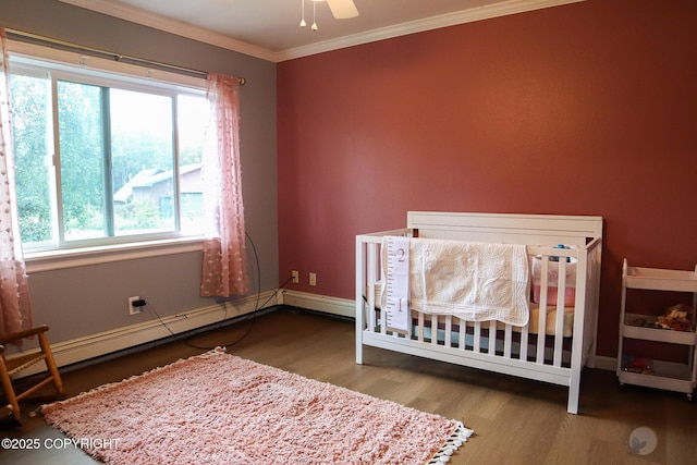 1468 Davison Rd, North Pole, AK 99705 - bedroom featuring a baseboard radiator, wood finished floors, baseboards, and ornamental molding