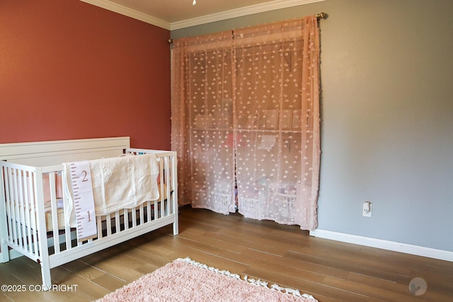 1468 Davison Rd, North Pole, AK 99705 - bedroom featuring wood finished floors, a crib, baseboards, and ornamental molding