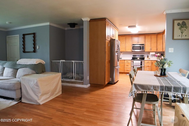 1468 Davison Rd, North Pole, AK 99705 - kitchen with open floor plan, light wood-style floors, appliances with stainless steel finishes, light countertops, and ornamental molding