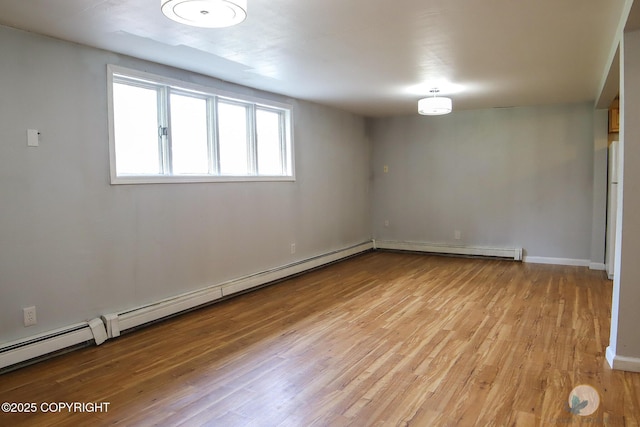 1468 Davison Rd, North Pole, AK 99705 - spare room featuring baseboard heating, baseboards, and light wood-type flooring