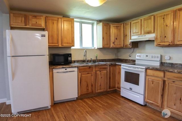1468 Davison Rd, North Pole, AK 99705 - kitchen featuring dark countertops, wood finished floors, a sink, white appliances, and under cabinet range hood