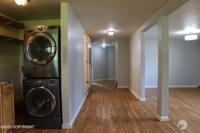 1468 Davison Rd, North Pole, AK 99705 - laundry room with baseboards, stacked washer / dryer, wood finished floors, and laundry area