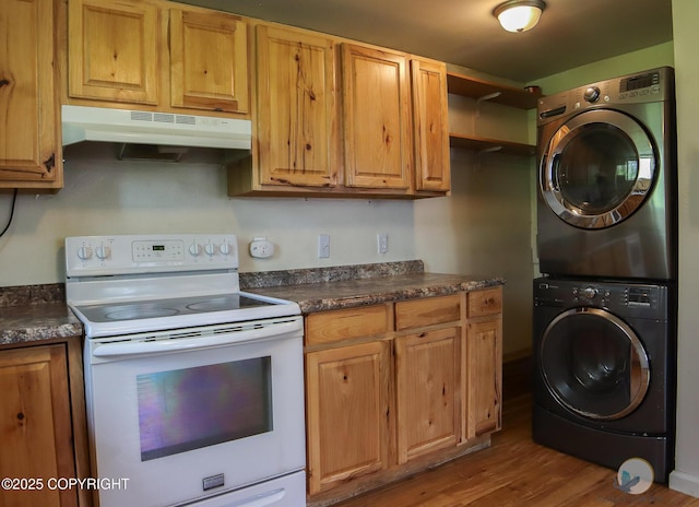 1468 Davison Rd, North Pole, AK 99705 - kitchen featuring dark countertops, wood finished floors, white electric stove, under cabinet range hood, and stacked washer and dryer