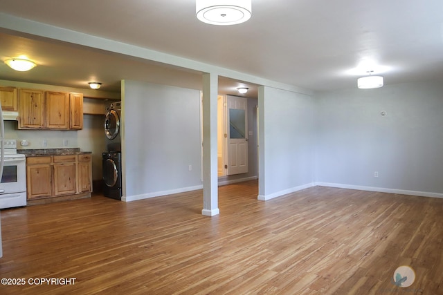 1468 Davison Rd, North Pole, AK 99705 - interior space featuring baseboards, white range with electric stovetop, wood finished floors, and stacked washer / drying machine