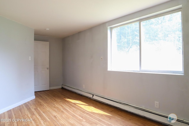 1468 Davison Rd, North Pole, AK 99705 - empty room featuring a baseboard radiator, baseboards, and light wood-style floors