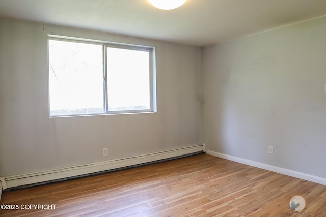 1468 Davison Rd, North Pole, AK 99705 - empty room with a baseboard heating unit, plenty of natural light, baseboards, and light wood-style flooring