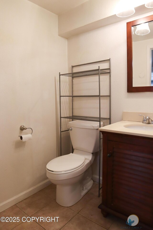 1468 Davison Rd, North Pole, AK 99705 - bathroom with vanity, toilet, baseboards, and tile patterned floors