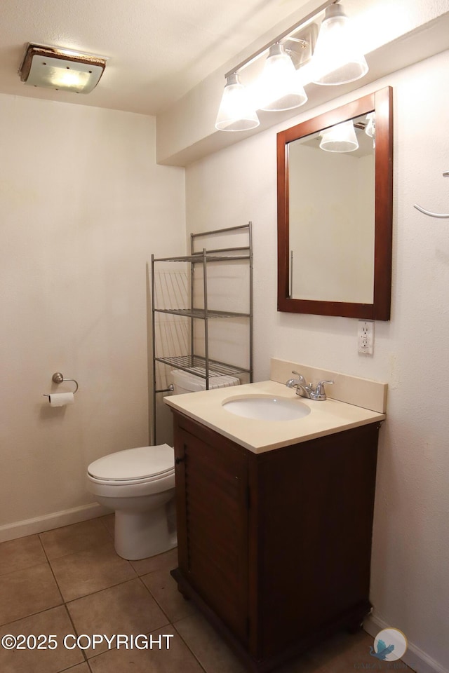 1468 Davison Rd, North Pole, AK 99705 - bathroom with tile patterned flooring, baseboards, toilet, and vanity