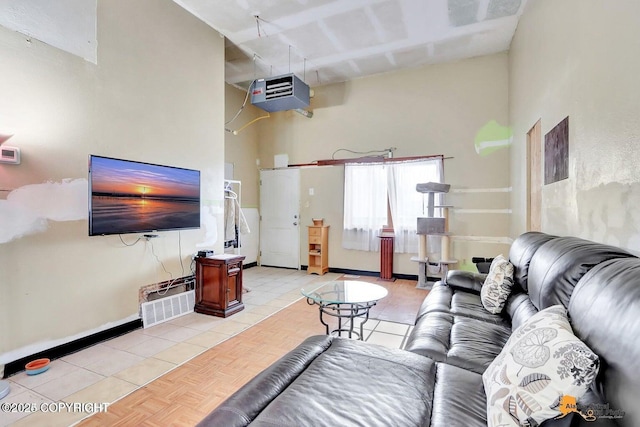 living area with light tile patterned floors and baseboards