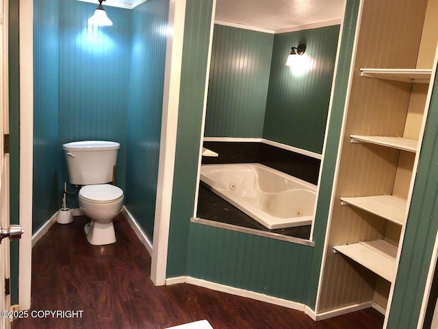 52899 Kingery Rd, Nikiski/North Kenai, AK 99611 - bathroom with a jetted tub, baseboards, toilet, and wood finished floors