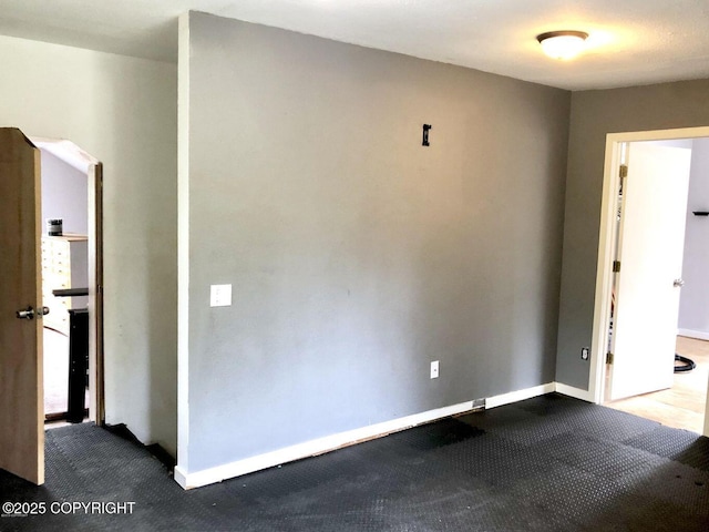 52899 Kingery Rd, Nikiski/North Kenai, AK 99611 - unfurnished room featuring dark colored carpet and baseboards