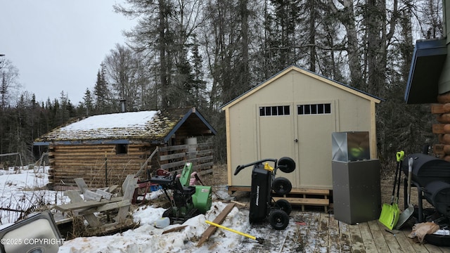 52899 Kingery Rd, Nikiski/North Kenai, AK 99611 - snow covered structure featuring a storage shed and an outbuilding