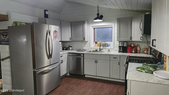 52899 Kingery Rd, Nikiski/North Kenai, AK 99611 - kitchen with dark wood-style floors, light countertops, lofted ceiling, stainless steel appliances, and a sink