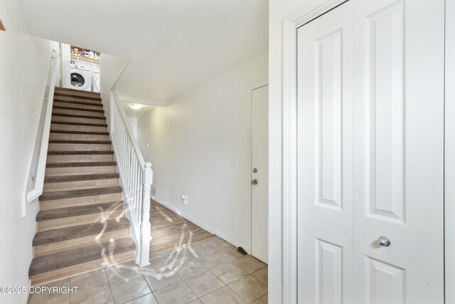 staircase with tile patterned flooring and washer / dryer
