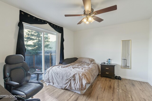 bedroom with baseboards, a ceiling fan, wood finished floors, and access to outside
