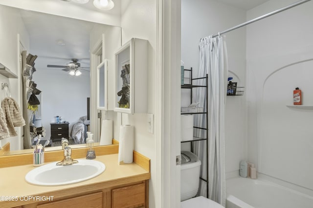 bathroom with ceiling fan, toilet, shower / bath combination with curtain, and vanity