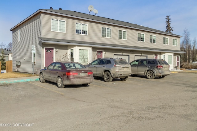 townhome / multi-family property featuring uncovered parking