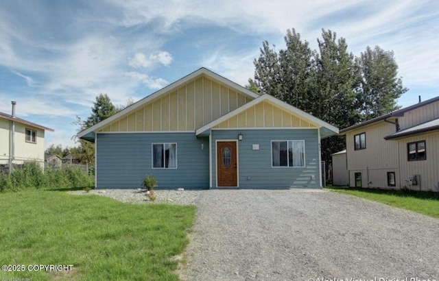 435 N Chugach St, Palmer, AK 99645 - view of front of home featuring board and batten siding, a front yard, and gravel driveway