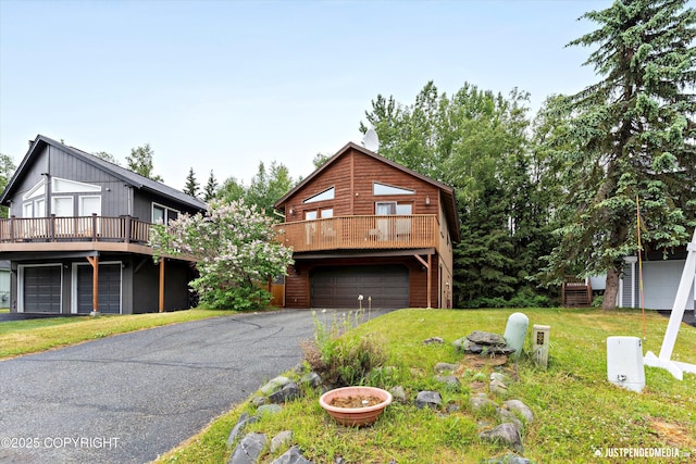 19111 Sarichef Loop, Eagle River, AK 99577 - chalet / cabin featuring an attached garage, a front lawn, a deck, and driveway