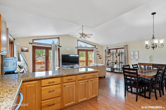 19111 Sarichef Loop, Eagle River, AK 99577 - kitchen featuring light wood finished floors, a chandelier, a peninsula, a ceiling fan, and lofted ceiling