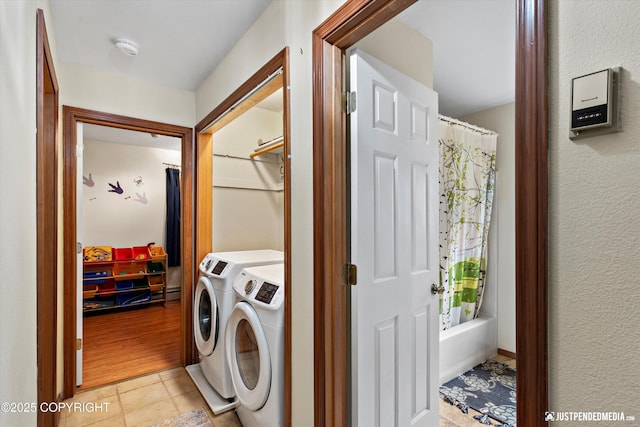 19111 Sarichef Loop, Eagle River, AK 99577 - laundry room with independent washer and dryer, light tile patterned floors, and a baseboard radiator