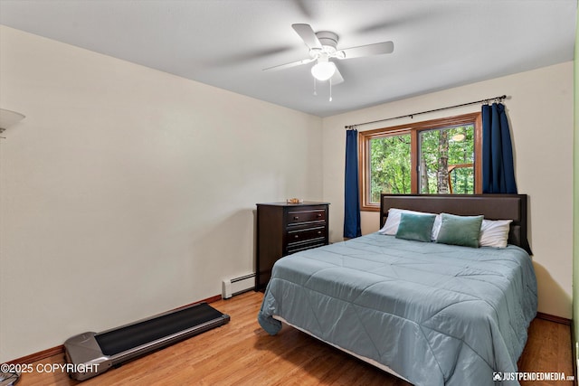 19111 Sarichef Loop, Eagle River, AK 99577 - bedroom featuring light wood finished floors, a baseboard radiator, and a ceiling fan