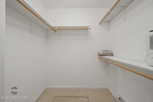 16627 River Heights Loop, Eagle River, AK 99577 - walk in closet featuring light colored carpet and a baseboard radiator
