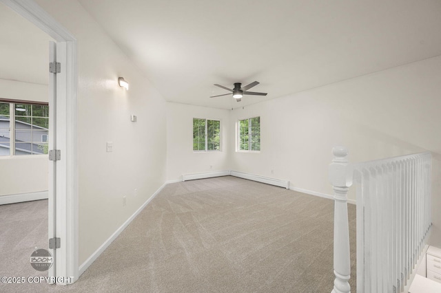 16627 River Heights Loop, Eagle River, AK 99577 - carpeted spare room with a ceiling fan, baseboards, and a baseboard radiator