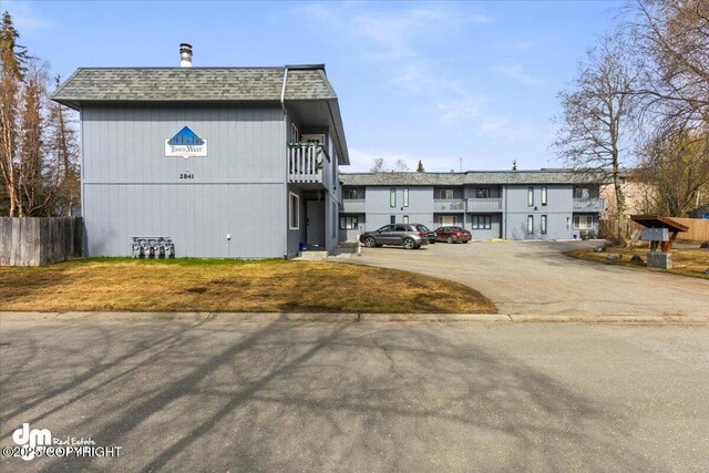 exterior space featuring fence and uncovered parking