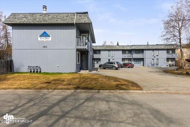 view of building exterior featuring uncovered parking
