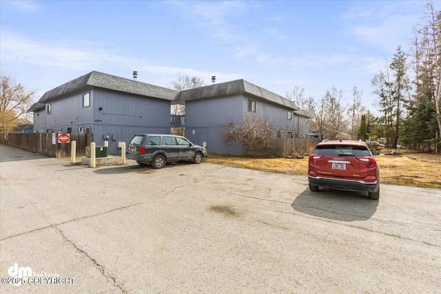 exterior space with fence and uncovered parking