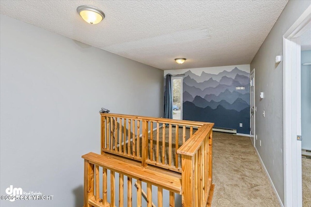 corridor featuring baseboards, carpet flooring, and a textured ceiling