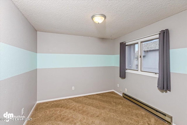 carpeted spare room featuring baseboards, a textured ceiling, and baseboard heating