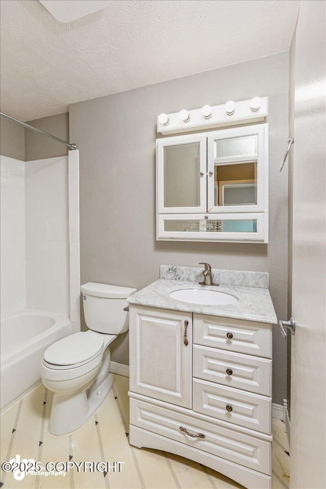 bathroom with tile patterned flooring, bathtub / shower combination, vanity, baseboards, and toilet