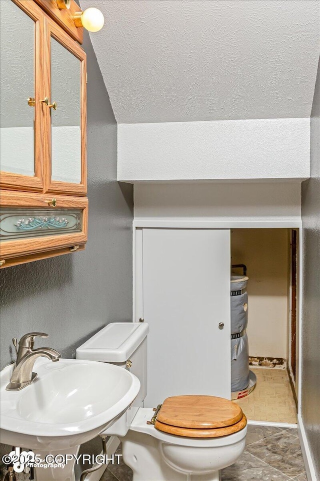 half bath featuring a sink and toilet