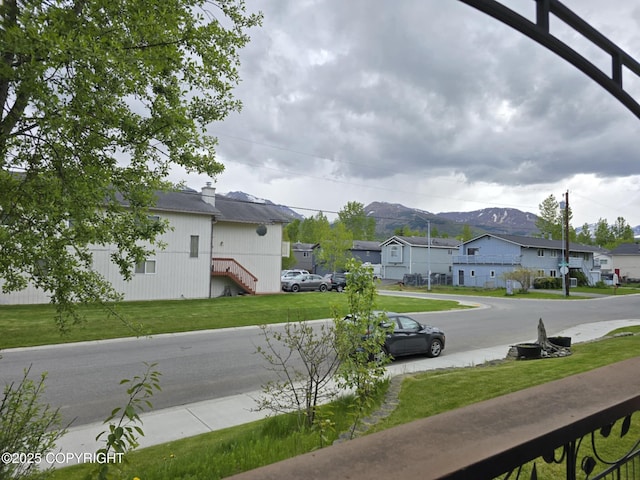 8041 Northwind Ave, Anchorage, AK 99504 - view of grassy yard featuring a residential view and a mountain view