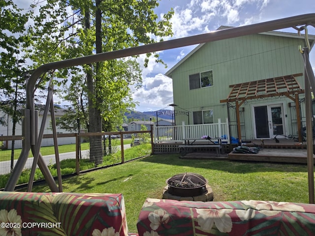 8041 Northwind Ave, Anchorage, AK 99504 - rear view of property with an outdoor fire pit, a wooden deck, and french doors