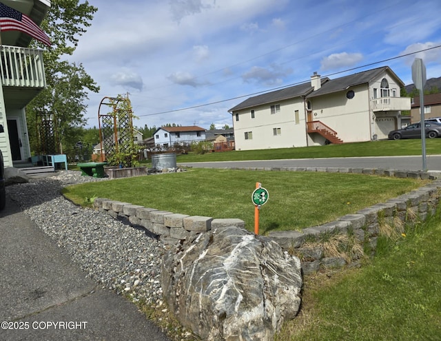 8041 Northwind Ave, Anchorage, AK 99504 - view of side of property featuring a lawn and a residential view