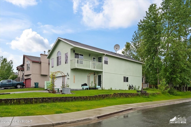 8041 Northwind Ave, Anchorage, AK 99504 - view of side of property with an attached garage, a balcony, a lawn, and driveway