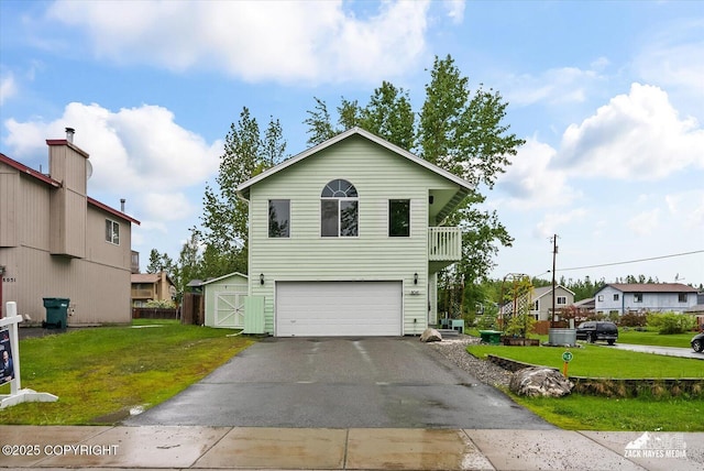 8041 Northwind Ave, Anchorage, AK 99504 - view of front of property with asphalt driveway, a front lawn, and an attached garage