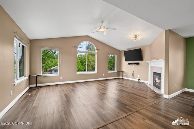 8041 Northwind Ave, Anchorage, AK 99504 - unfurnished living room with ceiling fan, wood finished floors, a fireplace, vaulted ceiling, and baseboards
