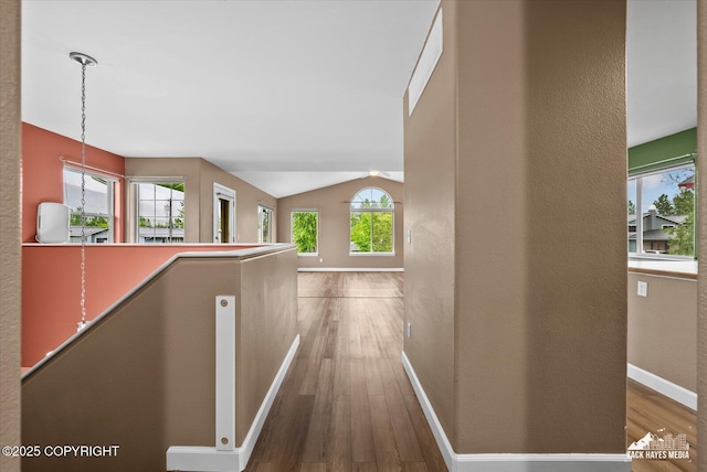8041 Northwind Ave, Anchorage, AK 99504 - hall featuring wood finished floors, a textured wall, baseboards, and lofted ceiling