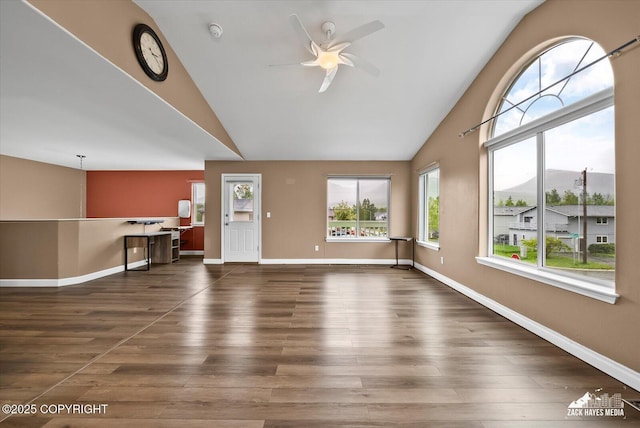 8041 Northwind Ave, Anchorage, AK 99504 - unfurnished living room featuring a ceiling fan, baseboards, wood finished floors, and high vaulted ceiling