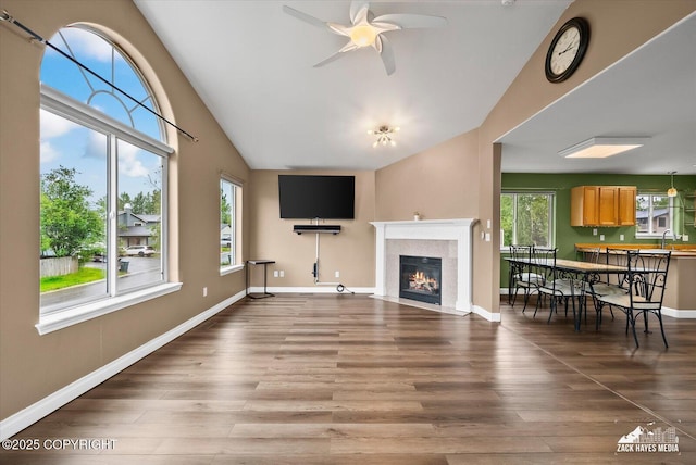 8041 Northwind Ave, Anchorage, AK 99504 - unfurnished living room with a sink, vaulted ceiling, ceiling fan, a premium fireplace, and wood finished floors