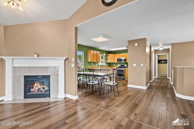 8041 Northwind Ave, Anchorage, AK 99504 - living area featuring wood finished floors, baseboards, and a fireplace with flush hearth